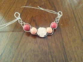 braided silver necklace piece with roses and pink beads